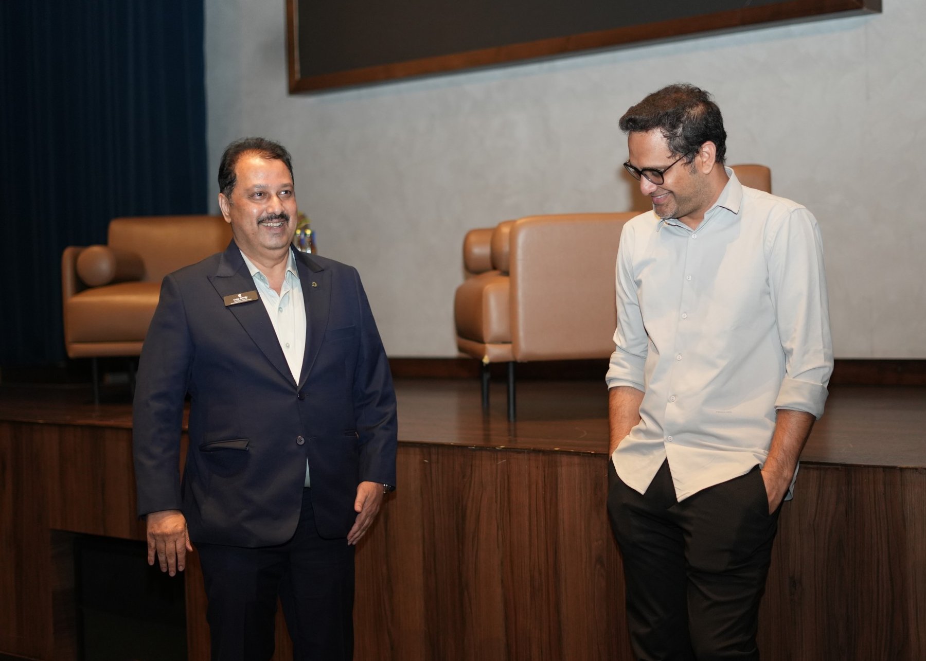 Uday Shetty standing with a guest near the CC stage